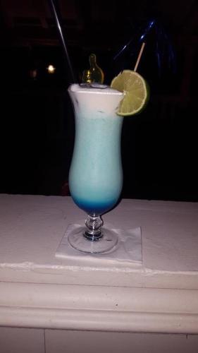 a blue drink with a lime on a table at Villa Natalija in Medulin
