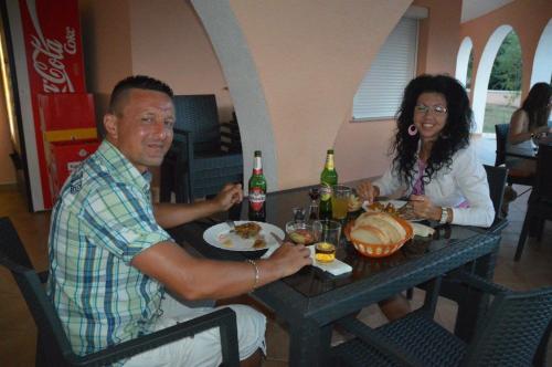 a man and a woman sitting at a table at Villa Natalija in Medulin