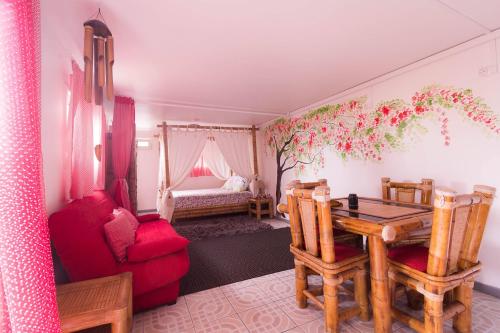 salon ze stołem i czerwoną kanapą w obiekcie Ambalabaa w mieście Saint-Philippe