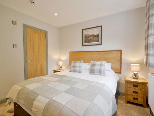 a bedroom with a large bed and two night stands at The Cayley Arms Inn in Pickering