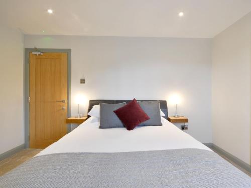 a bedroom with a large white bed with two pillows at The Cayley Arms Inn in Pickering
