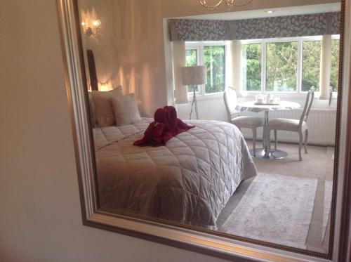 a bedroom with a bed with a large mirror at Oakleigh house in Stratford-upon-Avon
