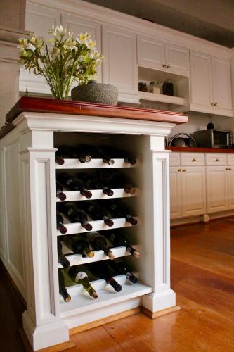 a wine rack in a kitchen with a bunch of wine bottles at Casa Toscana Bed & Breakfast in San Miguel de Allende