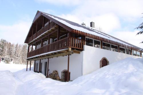 a building covered in snow with snow around it at Küljemäe puhkemaja in Otepää