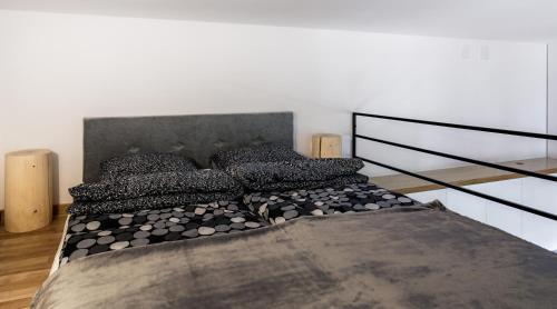 a bedroom with a large bed with black pillows at Miodowe mieszkanko in Krakow