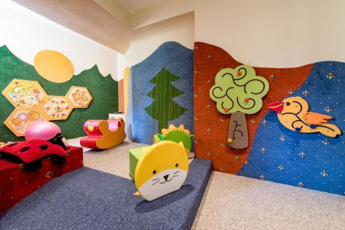 a childs bedroom with toys and a bed in a room at Hotel Krone in Mondsee