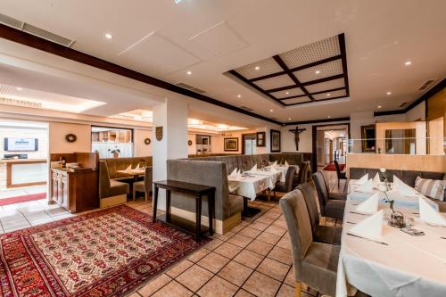 a dining room with tables and chairs in a restaurant at Hotel Krone in Mondsee