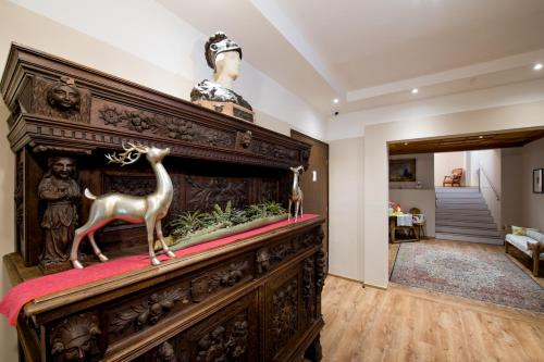 a large wooden altar with a statue of a deer on top at Hotel Krone in Mondsee
