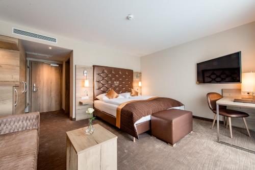 a hotel room with a bed and a desk at Hotel Krone in Mondsee