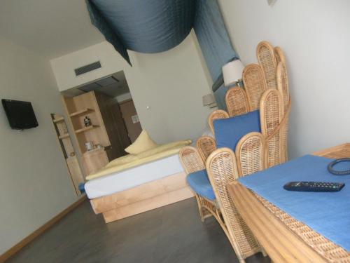 a room with a bed and chairs and a table at Beach Hotel Du Lac Malcesine in Malcesine