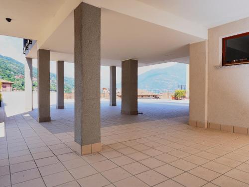 a room with columns and a tv on a wall at 7 Lake Sweet Home in San Siro