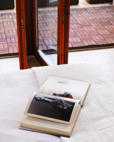 a book sitting on top of a bed at 7 Lake Sweet Home in San Siro