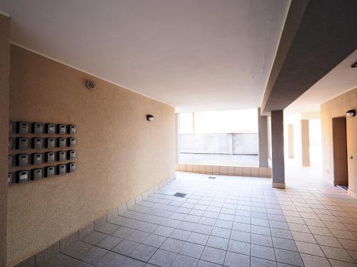 an empty hallway of a building with a large window at 7 Lake Sweet Home in San Siro