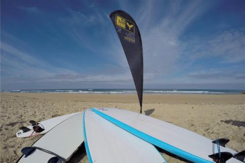 two surfboards and a banner on the beach at Vale de Lourinhã - Casas de Campo in Lourinhã