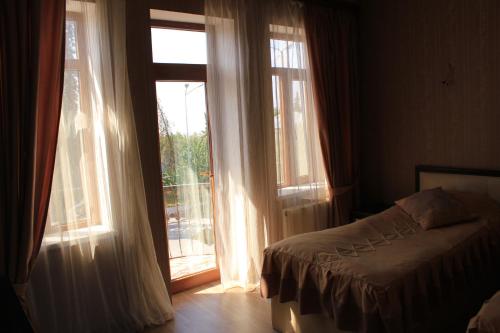 Postel nebo postele na pokoji v ubytování Ivanovka Guest House