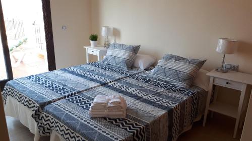 a bedroom with two beds with towels on them at Amazing terrace in Águilas in Águilas