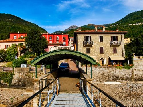 a small bridge over a river with a building at 7 Lake Sweet Home in San Siro