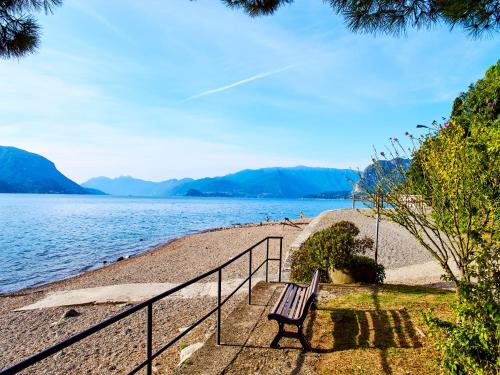 a bench sitting on the shore of a body of water at 7 Lake Sweet Home in San Siro