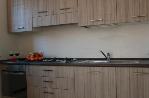 a kitchen with a sink and a counter with fruit on it at Residence Villa Paradiso in Gravedona