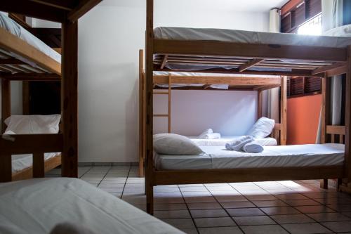 a bedroom with two bunk beds in a room at Blue Hostel in Natal