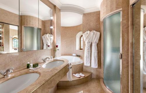 a bathroom with two sinks and a shower at Château Saint-Martin & Spa - an Oetker Collection Hotel in Vence