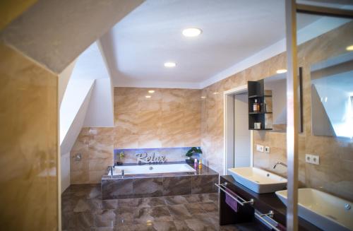 a large bathroom with a tub and a sink at Buri Island in Hoyerswerda