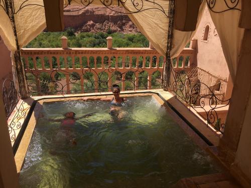 a couple of people in a swimming pool at Kasbah Titrit & Spa in Aït Ben Haddou