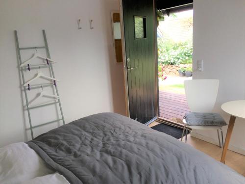 a bedroom with a bed and a ladder next to a door at Troense Bed and Breakfast by the sea in Svendborg