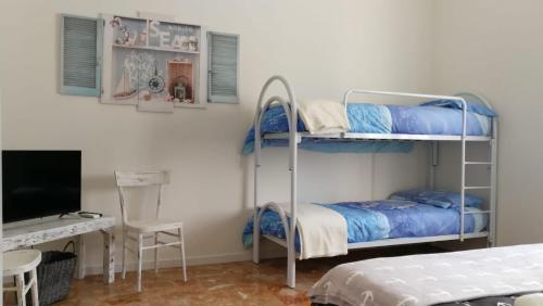 a bedroom with two bunk beds and a desk at Good Morning Shopping in Serravalle Scrivia