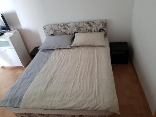 a bed with two pillows on it in a bedroom at Victoria Apartment in Ljubljana
