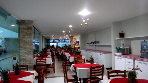 a dining room with tables and chairs in a restaurant at Simas Praia Hotel in Aracaju