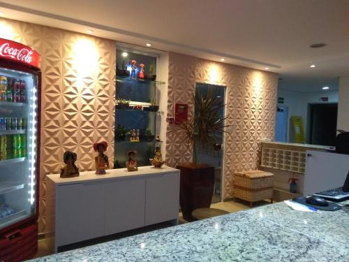 a room with a soda machine and a counter with a refrigerator at Simas Praia Hotel in Aracaju