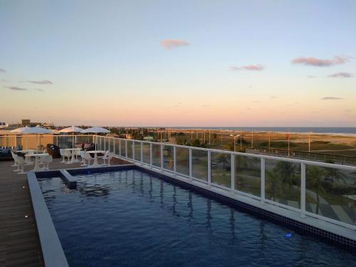 a swimming pool on the roof of a building at Simas Praia Hotel in Aracaju