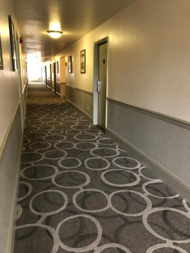 a hallway with a carpeted floor in a building at Howard Johnson by Wyndham Salem in Salem