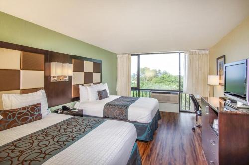a hotel room with two beds and a flat screen tv at Red Lion Hotel Monterey in Monterey
