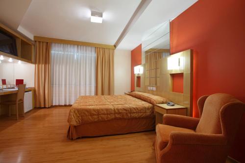 Un pat sau paturi într-o cameră la Scorial Rio Hotel