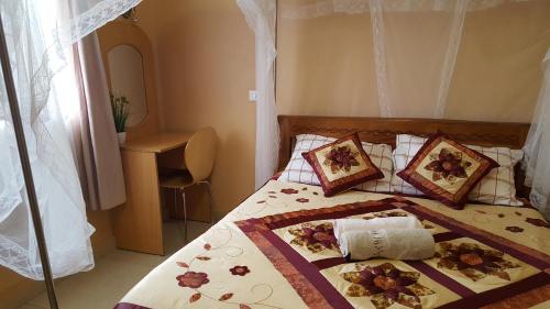 a bedroom with a bed with flowers on it at Achill Houses in Thika
