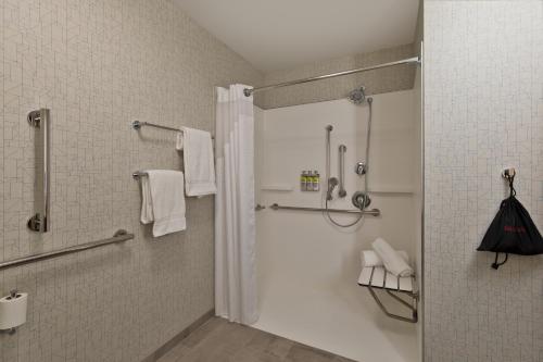 a bathroom with a shower with a glass door at Holiday Inn Express & Suites - Portland Airport - Cascade Stn, an IHG Hotel in Portland
