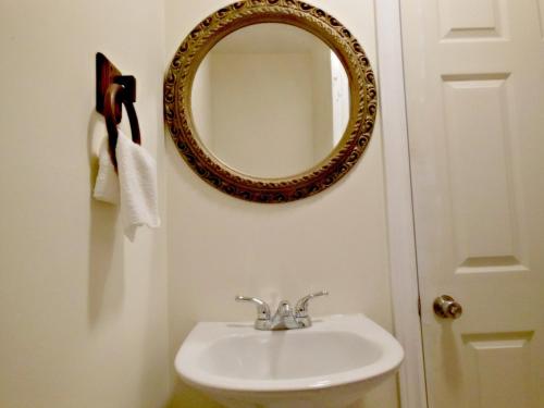 a bathroom with a sink and a mirror on the wall at Kent Motel in Chatham
