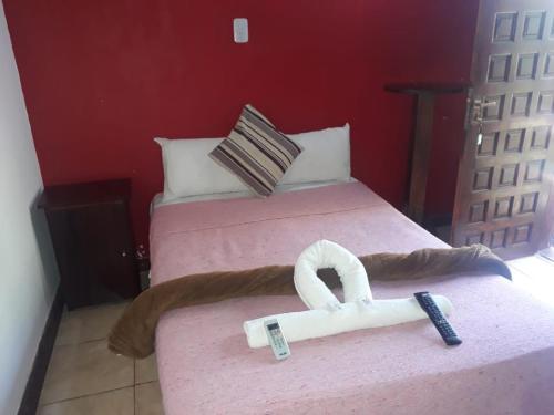 Ένα ή περισσότερα κρεβάτια σε δωμάτιο στο Petit Hotel Caraguata