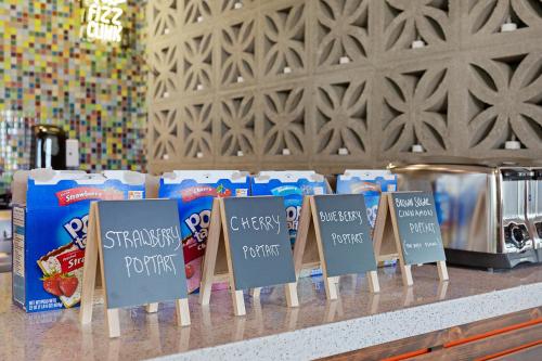 a counter with signs that say stress food and snacks at Hotel McCoy - Art, Coffee, Beer, Wine in Tucson
