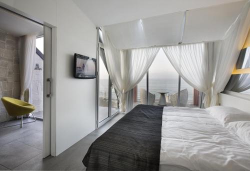 a bedroom with a large bed with a large window at Atik Hotel in Unye