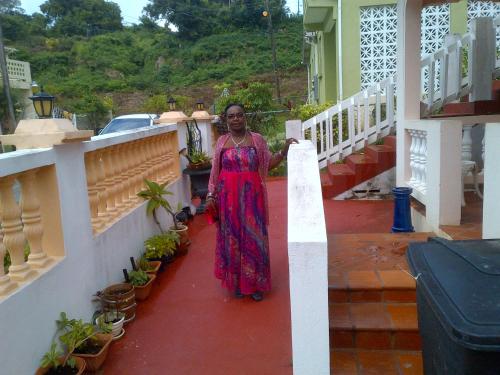 a woman standing on a balcony of a house at LeMarida Suites in Saint Peter