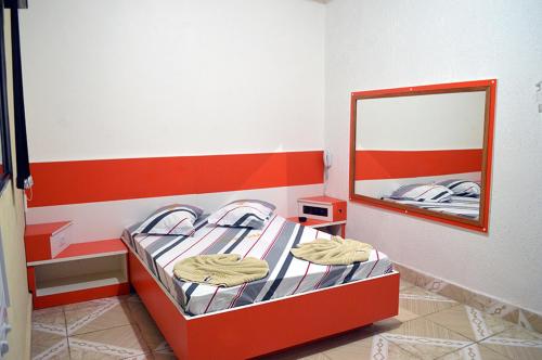 a small bedroom with a bunk bed with a mirror at Hotel Gold in Sao Paulo