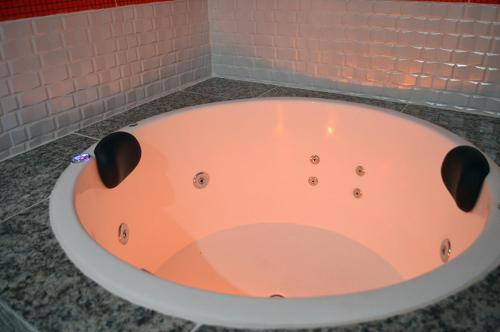 a bath tub sitting on a counter in a bathroom at Hotel Gold in Sao Paulo