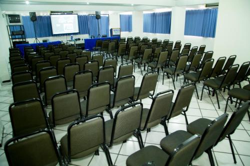 a room full of chairs in a lecture hall at Monza Palace Hotel in Natal