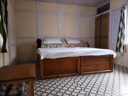 a small bedroom with a bed and a table at Vamoose Nehabo in Hāpoli