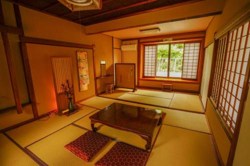 a living room with a table and a window at Onsen Yado Mizuguchi in Izu