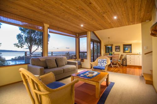 a living room with a couch and chairs and a table at The Wheelhouse Inn in Nelson