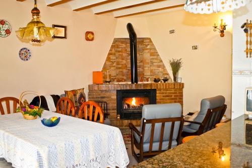 a living room with a table and a fireplace at La CasetA in Puebla de Benifasar